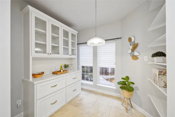 a kitchen that has a lot of furniture and a window