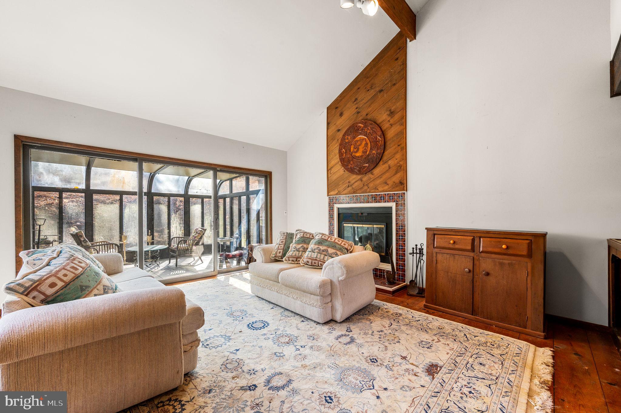 4134 Hollow Road Malvern, PA 19355 - Photo 13 of 36 Family room with fireplace and sun room