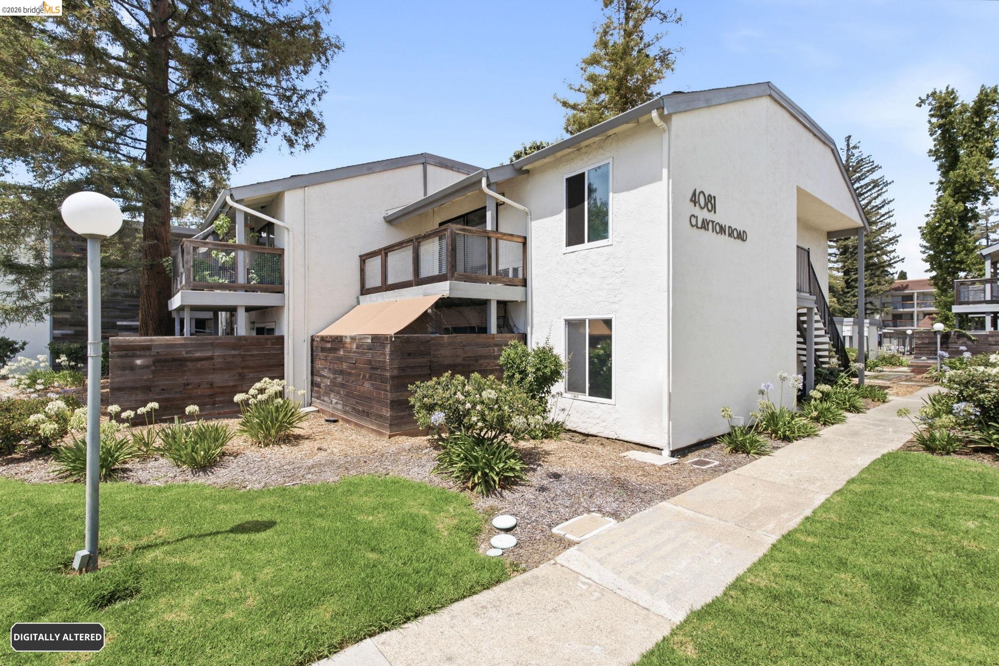 4081 Clayton Road, Unit 209 Concord, CA 94521 - Photo 2 of 47 Multi-level building with white stucco exterior and dark trim