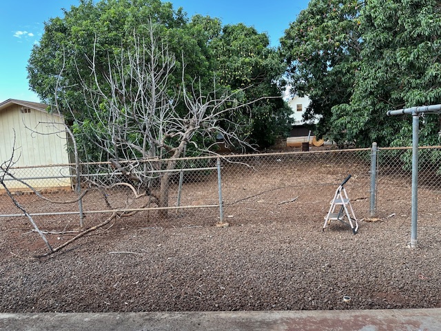 9622 Waena Road Waimea, HI 96796 - Photo 2 of 4 a wooden bench sitting in a backyard