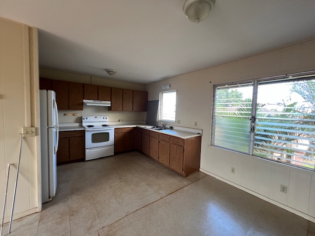 9622 Waena Road Waimea, HI 96796 - Photo 3 of 4 a large kitchen with a large window and stainless steel appliances