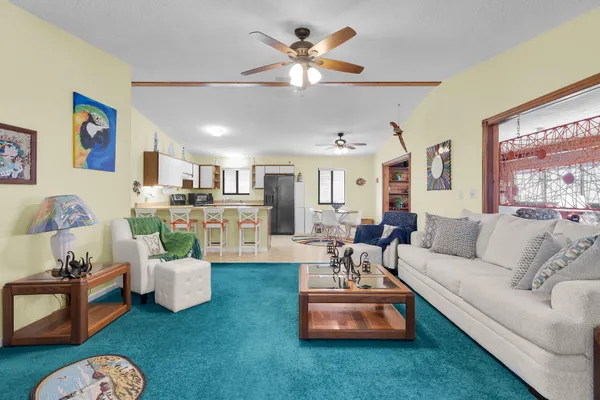 a view of a patio with table and chairs potted plants