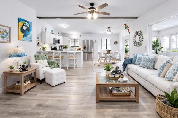 a dining room with stainless steel appliances a dining table and chairs
