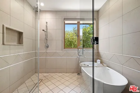 a bathroom with a bathtub and shower