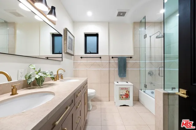 a bathroom with a sink double vanity and tub