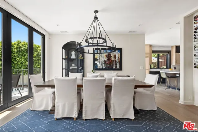 a living room with couches a coffee table and a large window with garden view
