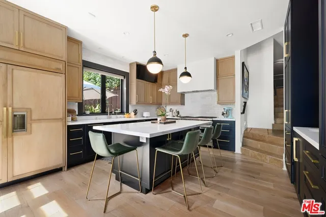 a large kitchen with a table and chairs