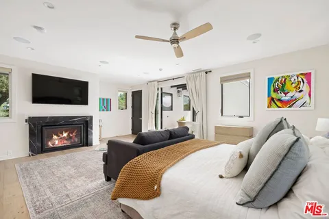 a bedroom with a bed furniture and a fireplace