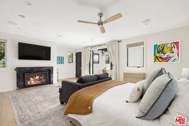 a bedroom with a bed furniture and a fireplace