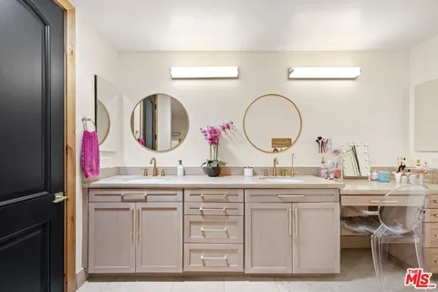 a room with a bathroom sink and a mirror
