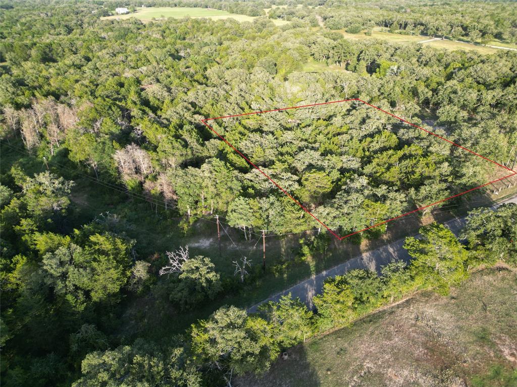 Tbd Lot 1 Tbd Road Smithville, TX 78957 - Photo 2 of 12 Aerial view of property's location with property boundaries highlighted and a heavily wooded area