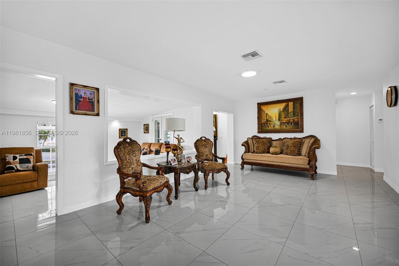 756 West 53rd Street Hialeah, FL 33012 - Photo 12 of 65 a living room with furniture and a gym