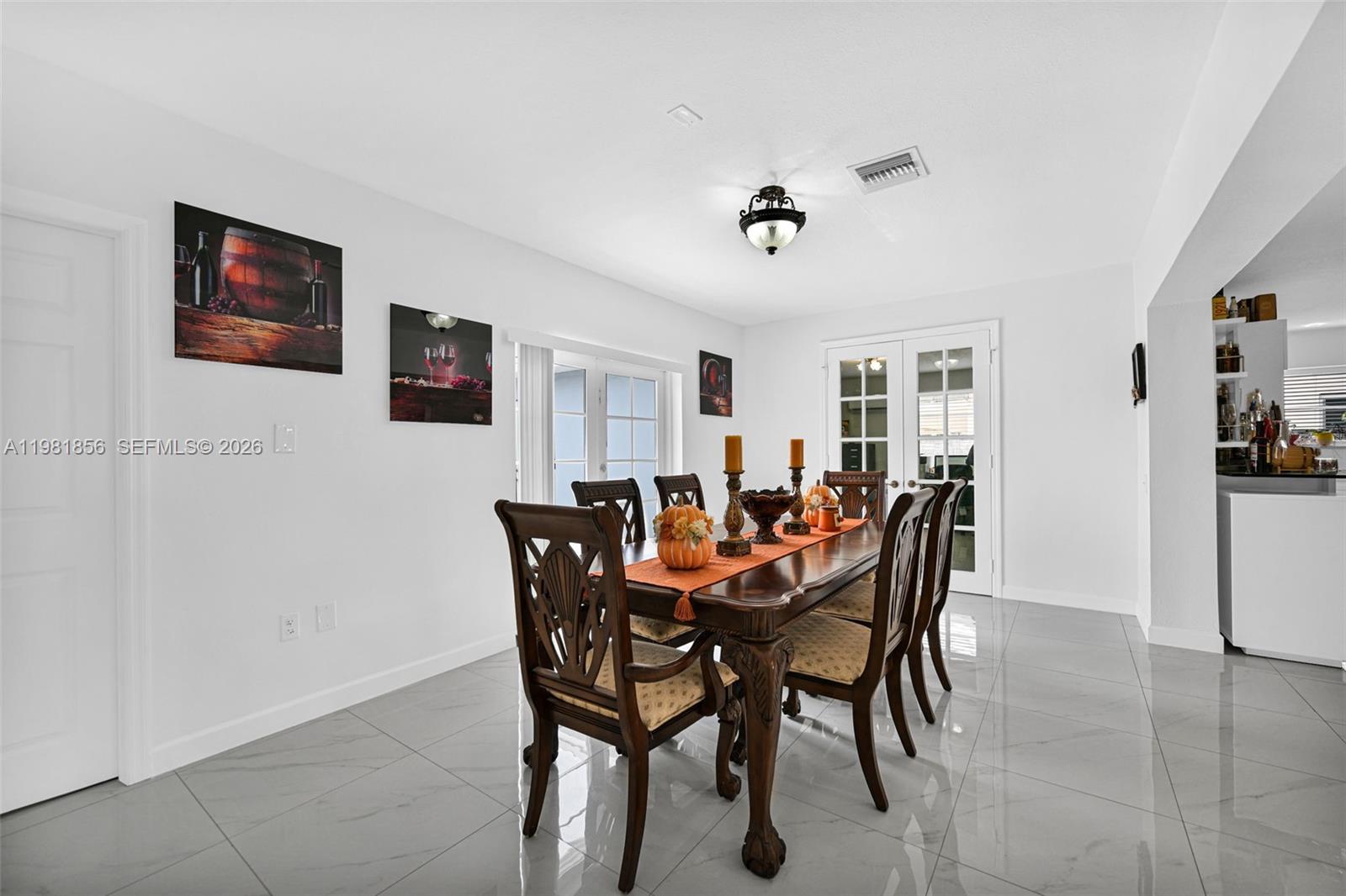756 West 53rd Street Hialeah, FL 33012 - Photo 16 of 65 a view of a dining room and livingroom with furniture