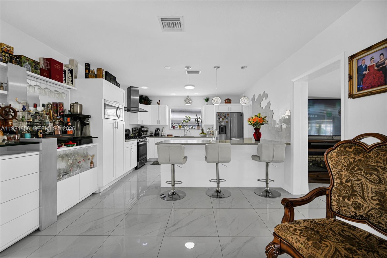 756 West 53rd Street Hialeah, FL 33012 - Photo 17 of 65 a living room with furniture and white cabinets