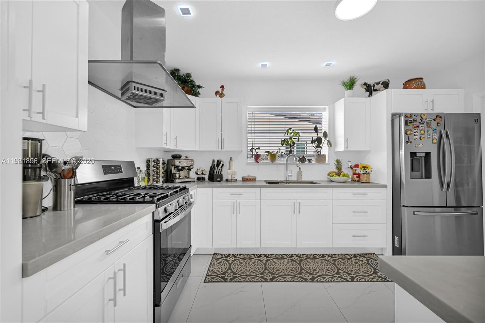 756 West 53rd Street Hialeah, FL 33012 - Photo 19 of 65 a kitchen with stainless steel appliances cabinets and a counter top space