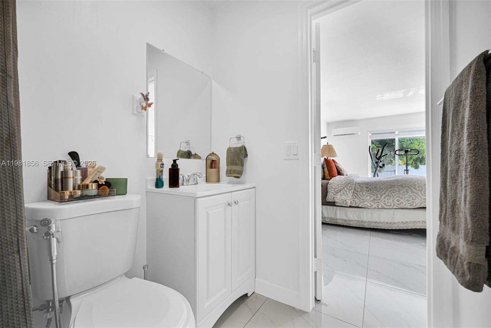 756 West 53rd Street Hialeah, FL 33012 - Photo 28 of 65 a en suite bathroom with a toilet a sink and mirror