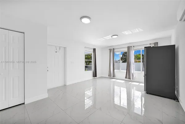 an aerial view of residential houses with outdoor space and ocean view