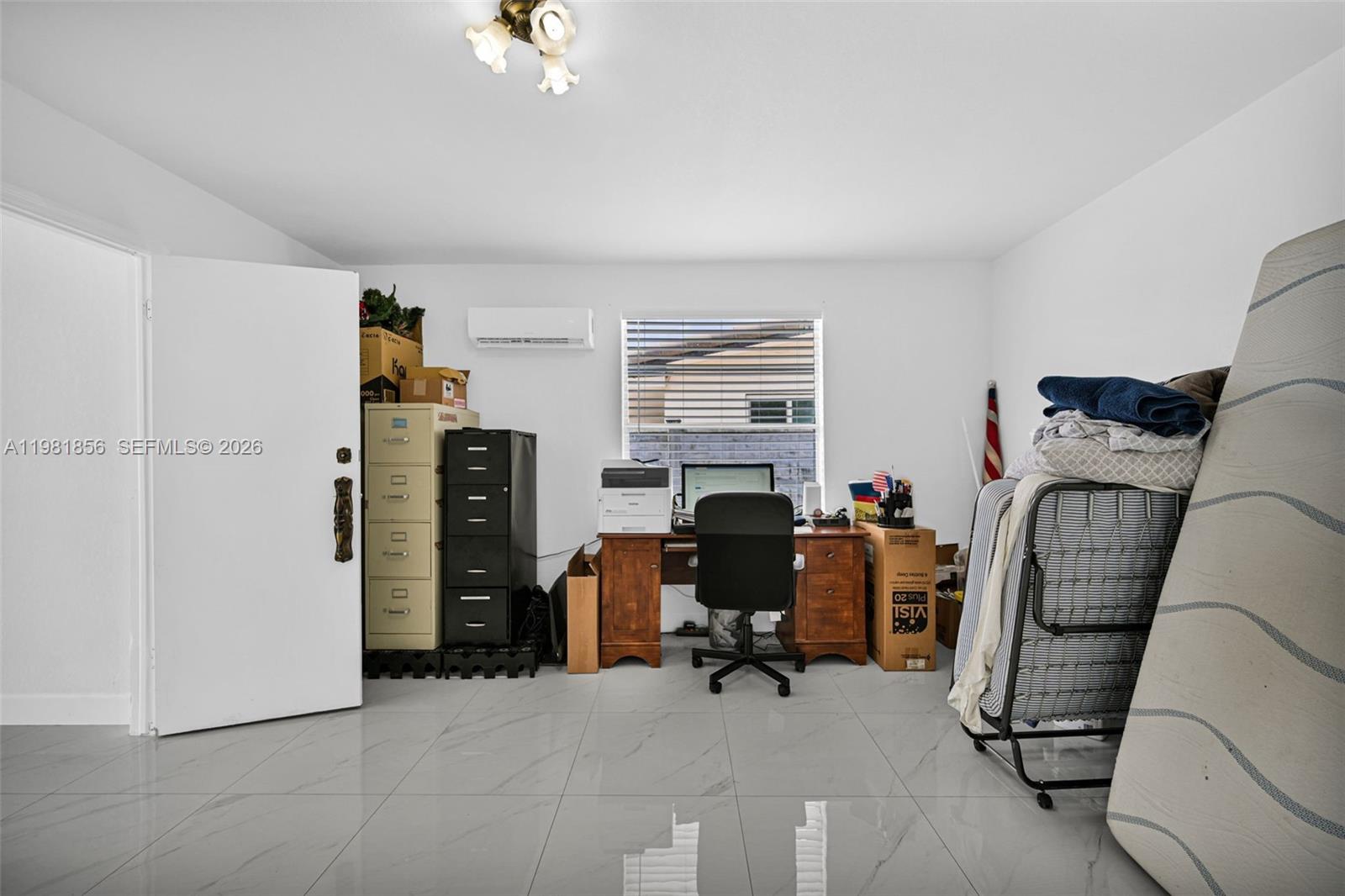 756 West 53rd Street Hialeah, FL 33012 - Photo 38 of 65 a view of a workspace with furniture and a window