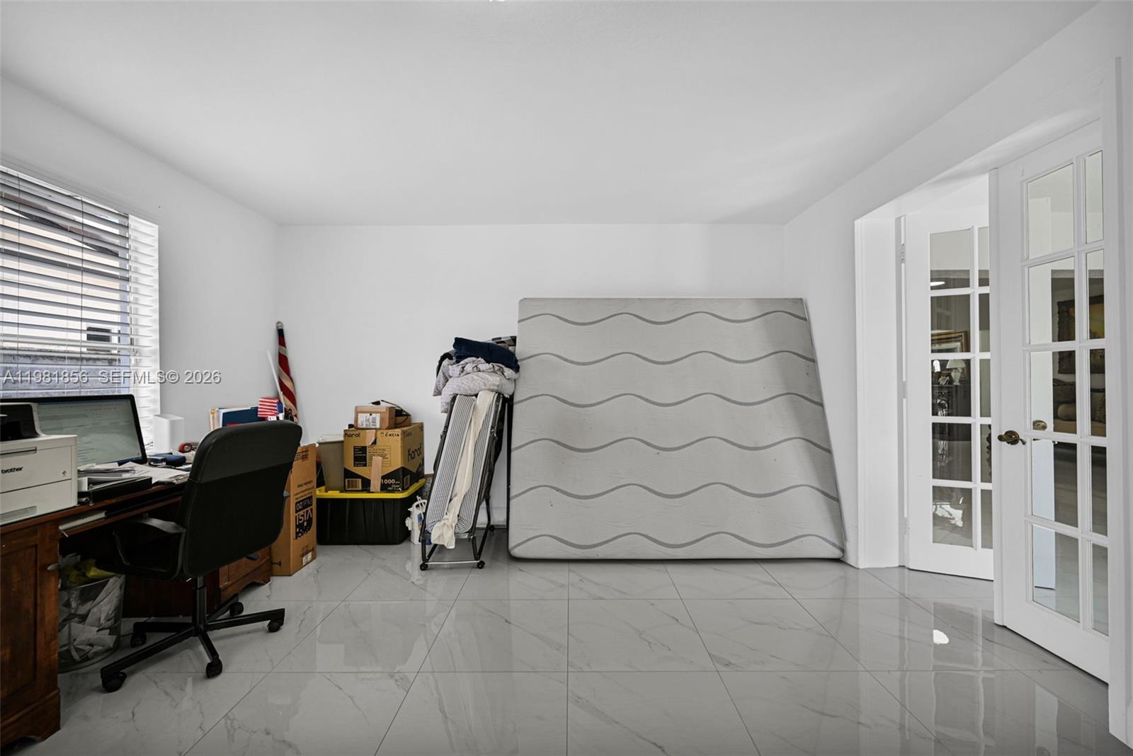 756 West 53rd Street Hialeah, FL 33012 - Photo 39 of 65 a view of a workspace with furniture and a window