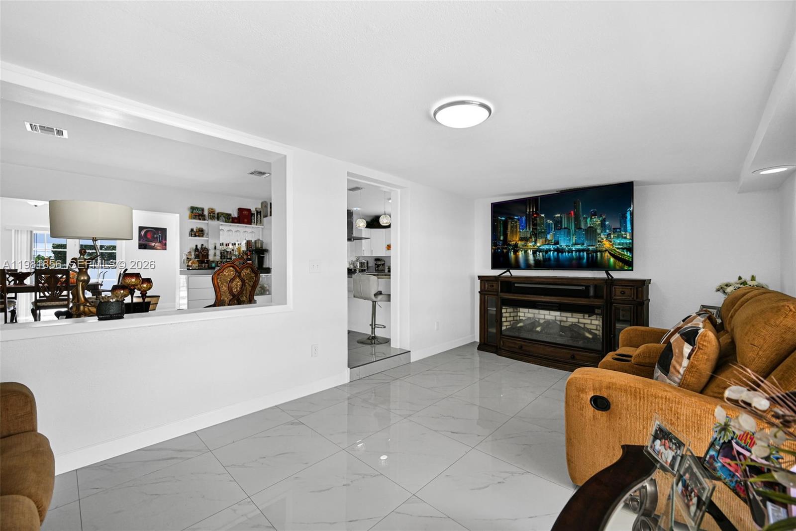 756 West 53rd Street Hialeah, FL 33012 - Photo 9 of 65 a living room with furniture and a flat screen tv