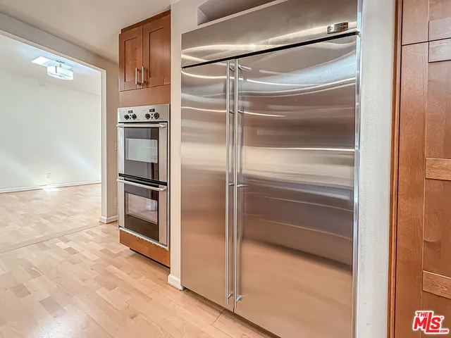 a refrigerator freezer and a stove sitting inside of a kitchen