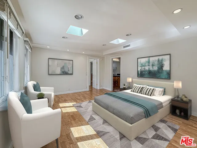 a bedroom with furniture and a painting on the wall