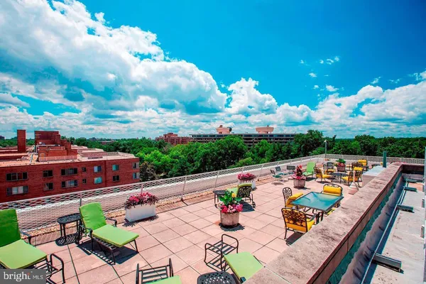 a view of city from balcony with seating space
