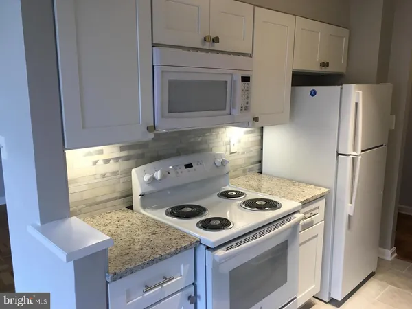 a kitchen with a stove and a refrigerator