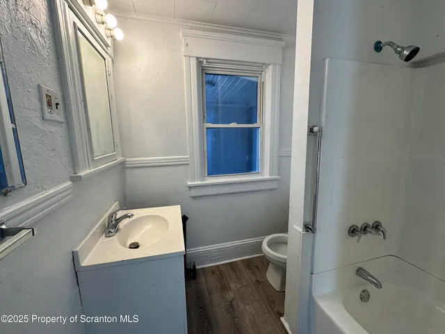 a bathroom with a bathtub sink and toilet