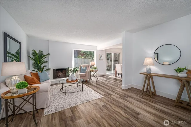 a living room with furniture a potted plant and a large window