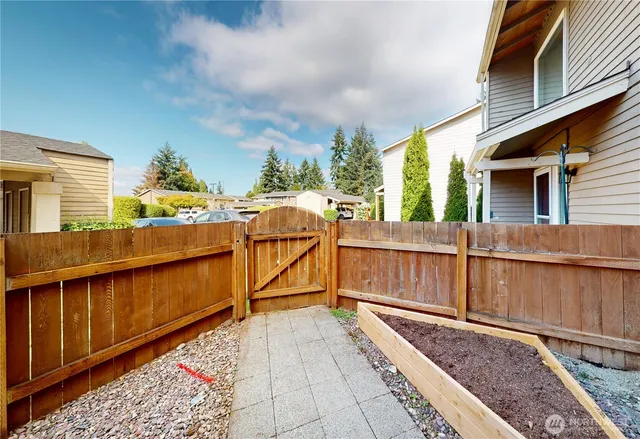 a view of a balcony with wooden floor and outdoor seating