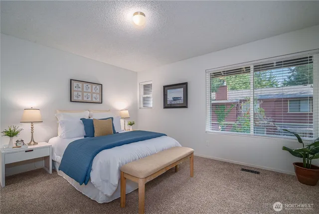 a spacious bedroom with a bed and a window