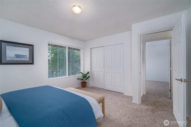 a bed sitting in a bedroom next to a window