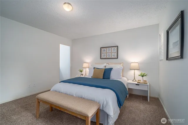 a bedroom with a bed and a lamp