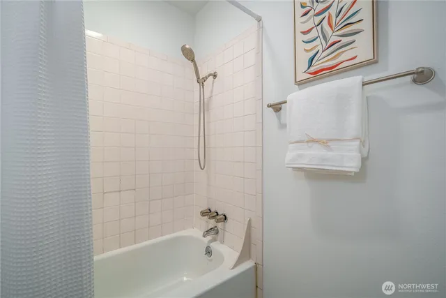 a bathroom with a bathtub and shower