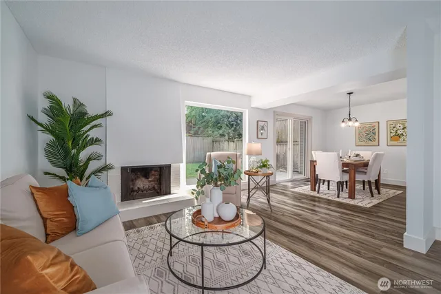 a living room with furniture potted plant and a large window