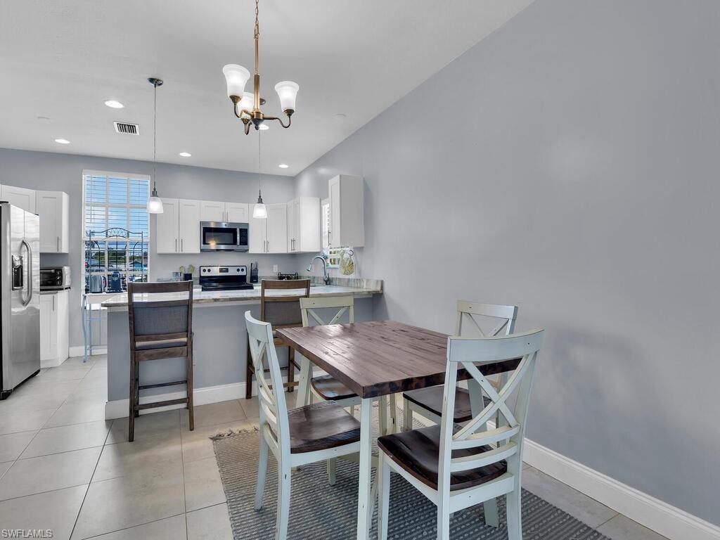 2160 43rd Terrace Southwest, Unit 49 Naples, FL 34116 - Photo 5 of 22 Dining Area & Breakfast Bar