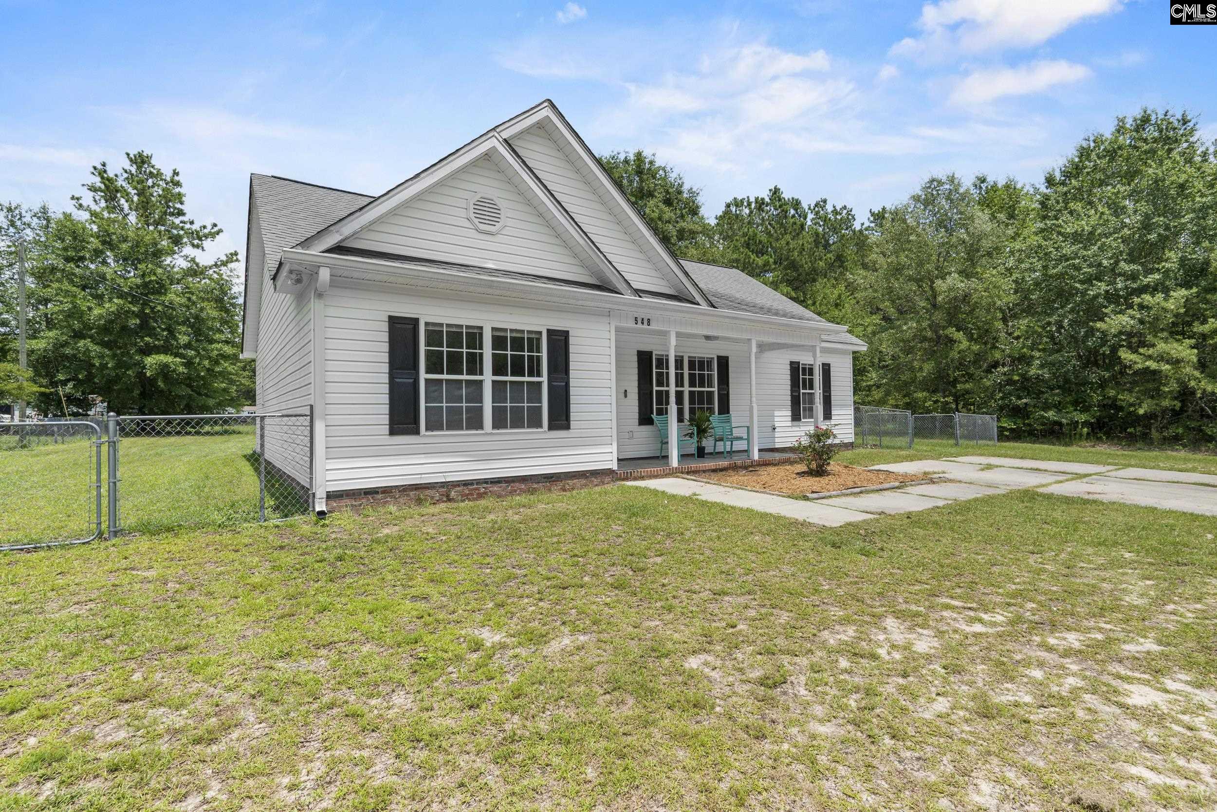 548 Eskie Dixon Road Elgin, SC 29045 - Photo 2 of 27 a view of a house with a swimming pool and a yard