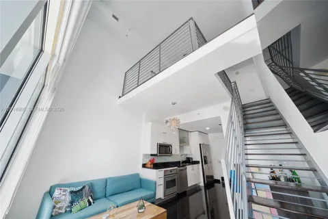 a view of a livingroom with furniture and stairs