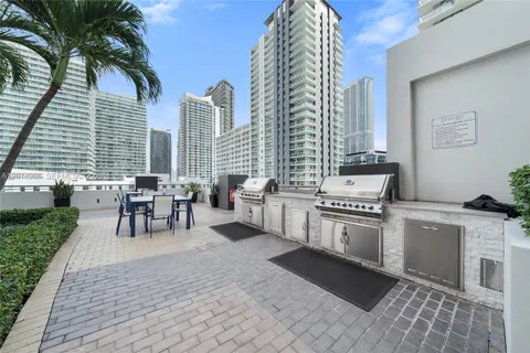 a kitchen with stainless steel appliances granite countertop a stove a sink and a chair