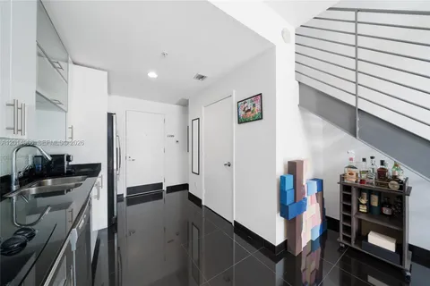 a view of a kitchen with fridge and workspace