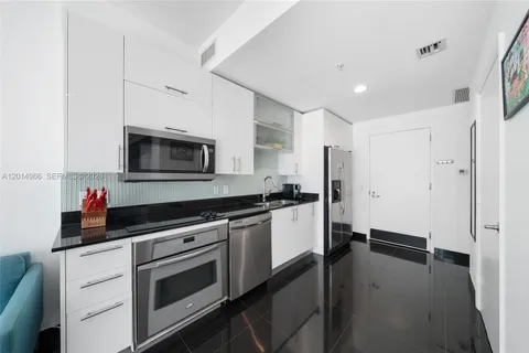 a kitchen with a sink and a stove top oven