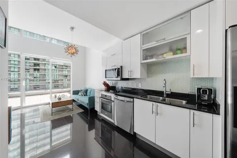 a kitchen with granite countertop a sink and a stove top oven