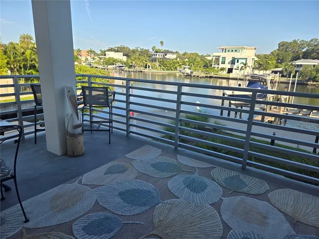 a view of a balcony with chairs and a potted plant