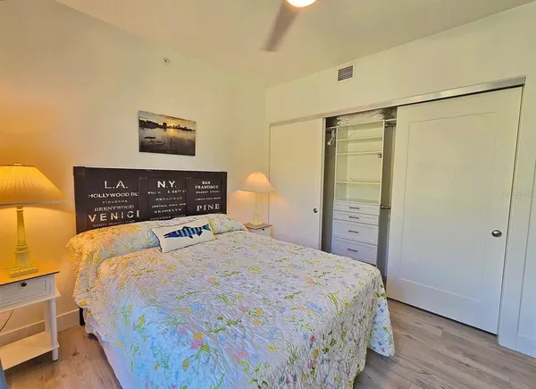 a bedroom with a bed and a night stand