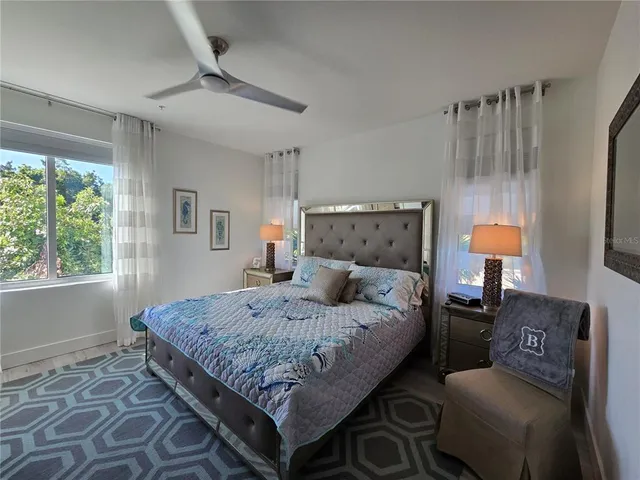 a bedroom with a bed window and couch