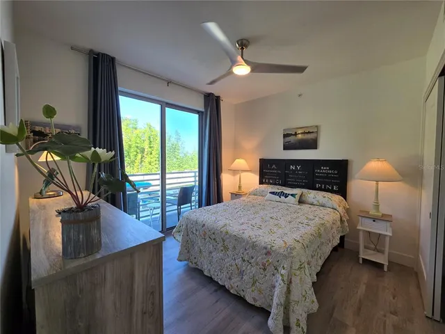 a bedroom with a bed and wooden floor