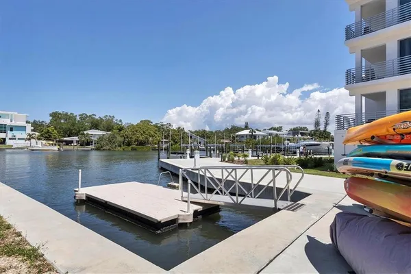 a view of a lake with couches chairs and a table