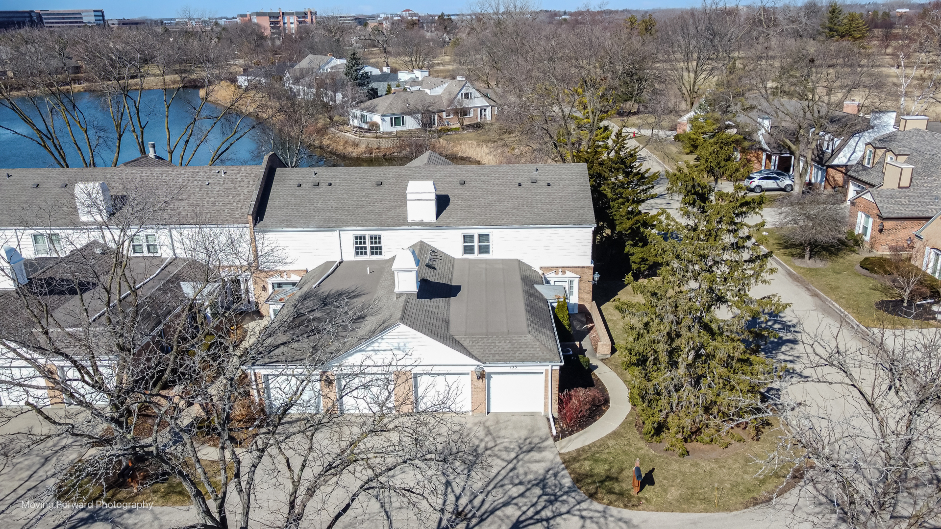 an aerial view of a house with a yard and sitting space