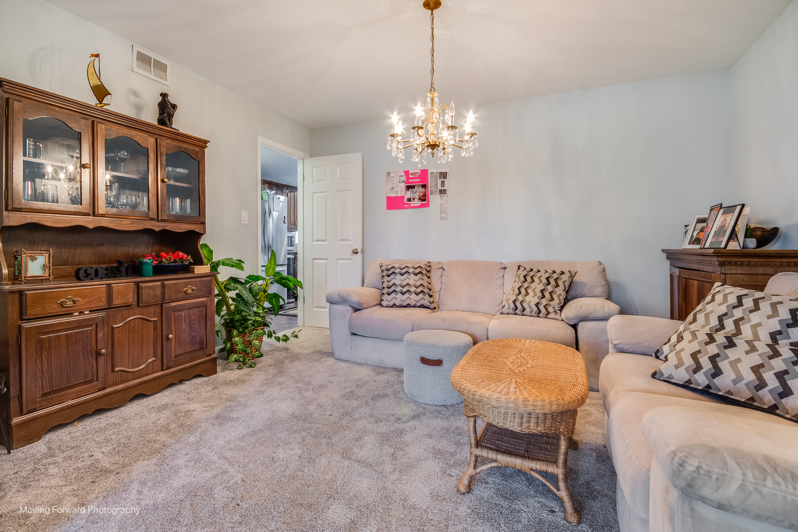 133 Rivershire Lane Lincolnshire, IL 60069 - Photo 7 of 26 a living room with furniture and a chandelier